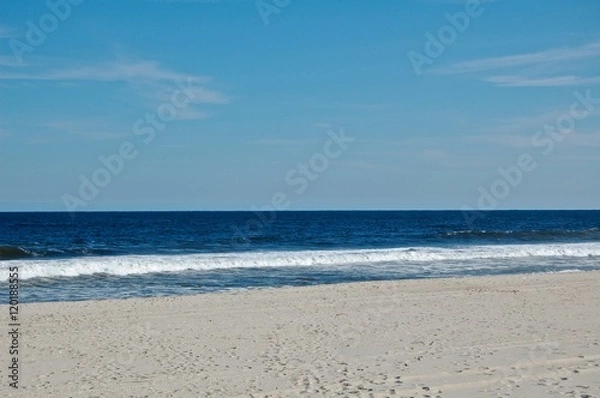 Obraz Sunny beach day, waves crashing and blue skies 