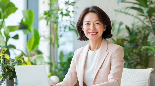 Obraz Professional woman smiling in modern office with greenery