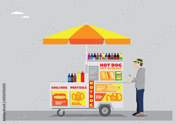 Fototapeta a hotdog stall with yellow and red color with umbrella and moving wheels selling sodas hotdog chilli dog and pretzels run by young man