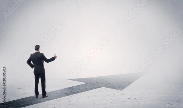 Fototapeta Standing salesman looking ahead with arrow