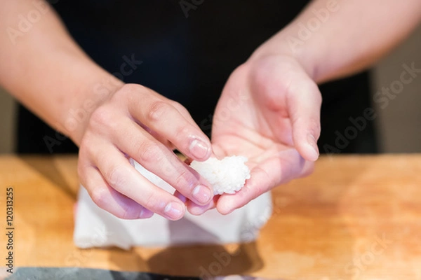 Fototapeta Close up hand of Japanese chef making sushi
