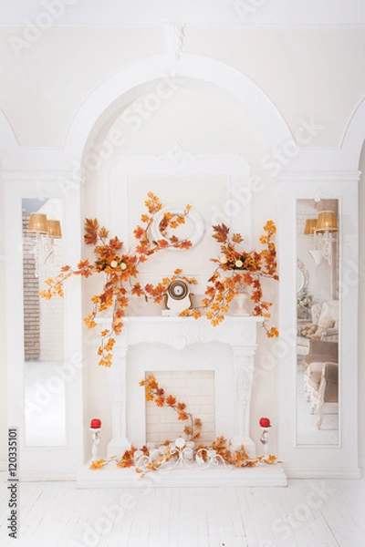 Obraz White classical fireplace in large hall with autumn decoration