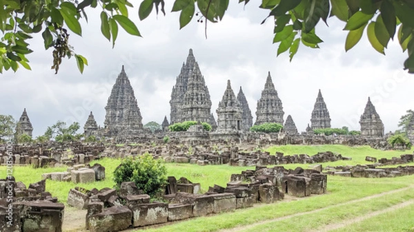 Obraz Straight angle view. the Prambanan Temple, Central Java, Indonesia with Scattered solid masonry and greeny leaves as front ground