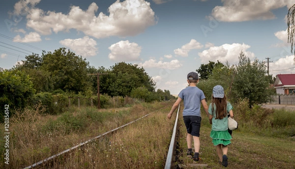 Obraz Children alone walking down old train track