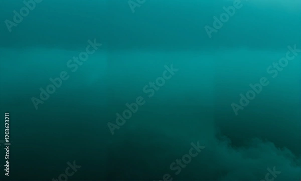 Fototapeta   A misty scene with a deep teal fog fading away into darkness, revealing intricate details of its absorption and the delicate meeting between light and shadow.
