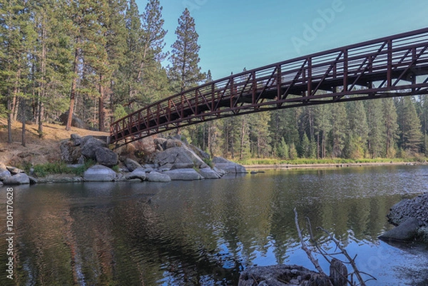 Fototapeta Photo of walk bridge at Winchester State Park on the Camas Prairie in Idaho reflecting in Winchester Lake