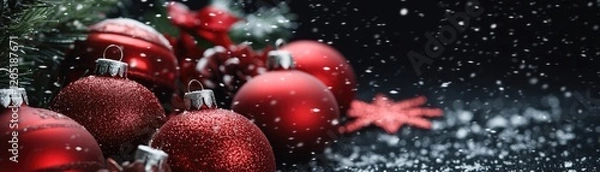 Fototapeta A festive arrangement of red Christmas ornaments surrounded by snowflakes and greenery.