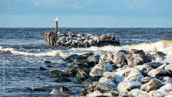 Fototapeta landscape with the seashore, windy winter day, water splashes, stone pier on the seashore, Baltic Sea, Latvia