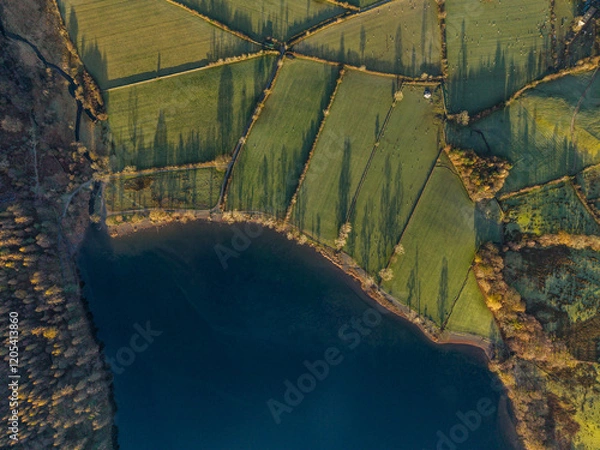 Fototapeta Dramatic aerial drone landscape in Autumn Winter of snowcapped mountains around Buttermere in Lake District at sunrise