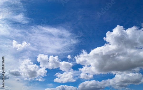 Obraz Magnificent cumulus clouds high in blue sky