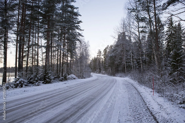 Fototapeta Slippery winter road on a cloudy winter day. Image taken after first snow has arrived in Finland.