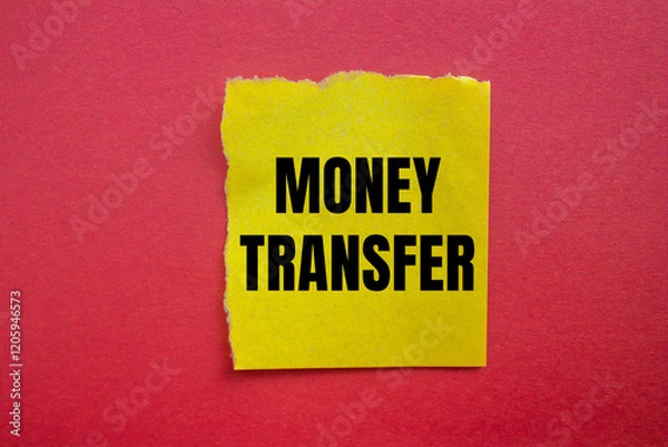 Fototapeta Money transfer message written on ripped torn yellow paper piece with red background. Conceptual money transfer symbol. Copy space.