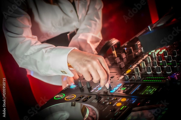 Obraz Close up DJ plays live set and mixing music on turntable console in the night club. Disc Jokey Hands on a sound mixer station at club party. DJ mixer controller panel for playing music and partying.