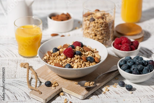Obraz breakfast with homemade granola with nuts and berries