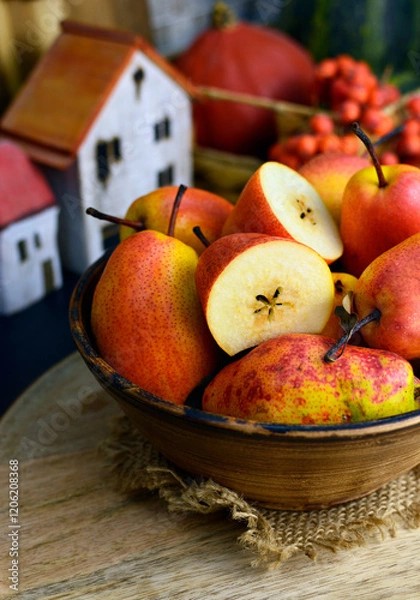 Fototapeta RED WILLIAM PEARS whole fruit and cut in half in a bowle. Known for its stunning deep red skin and soft, buttery texture. These sweet pears have red freckles, reminiscent of a Rainbow trout's skin