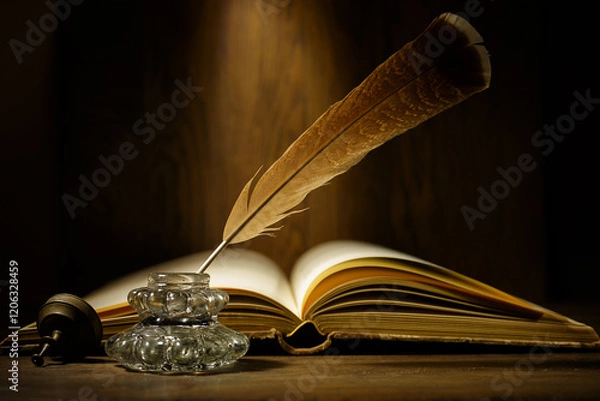 Fototapeta Open antique book with feather and ink bottle on old wooden table. Feather for calligraphy, old education, vintage still life.