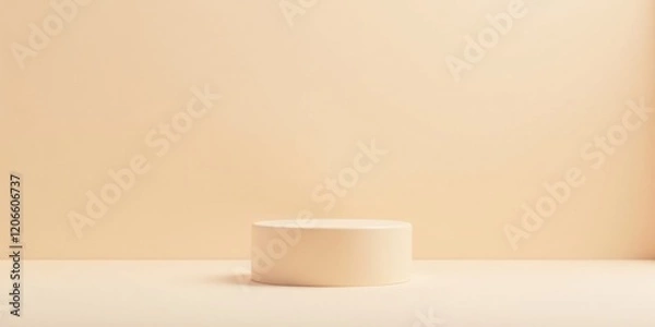 Fototapeta A Simple Pale Yellow Cylinder on a Matching Surface Against a Coordinating Background