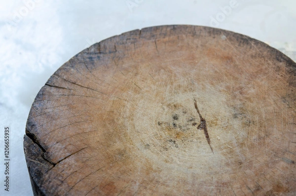 Fototapeta Close-up photo of a rustic wooden cutting board with natural cracks and texture. Perfect for use in the kitchen or in a cooking theme