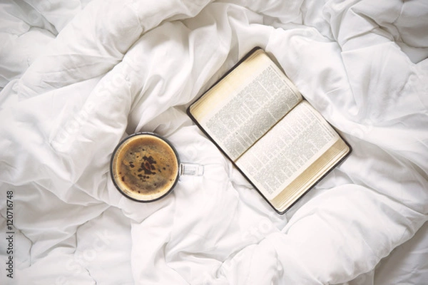 Obraz Cup of coffee and a book on bed