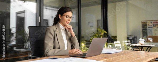 Fototapeta Young businesswoman professional employee using pc doing online banking analysing at workplace. Latin hispanic middle age business woman working on laptop computer in modern office. Banner, copy space