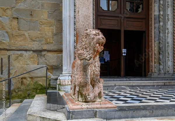 Fototapeta Bergamo, Italy. Lion statue front of Basilica of Santa Maria Maggiore in Citta Alta. Historical cathedral architecture of Old town.