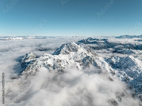 Fototapeta Snowy Peaks above the Clouds in Nassfeld Gartnerkofel Austria