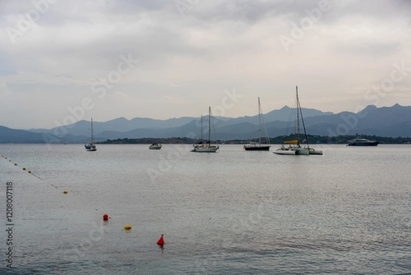 Fototapeta Sailing boats in the coast of Sardinia on a cloudy day in Italy