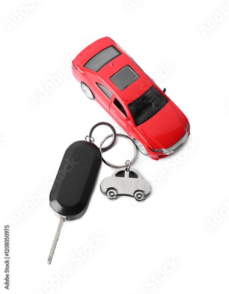 Fototapeta Car key with keychain and toy isolated on white, top view. Buying auto