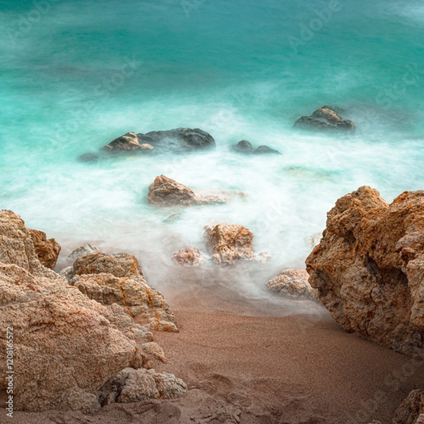 Obraz long exposure against the rocks on the beach