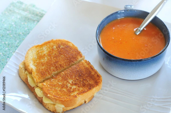 Obraz Grilled cheese and tomato bisque on plate with spoon