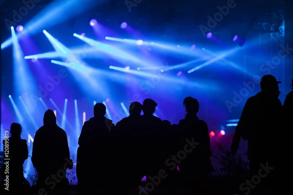 Fototapeta Cheering crowd in front of stage lights