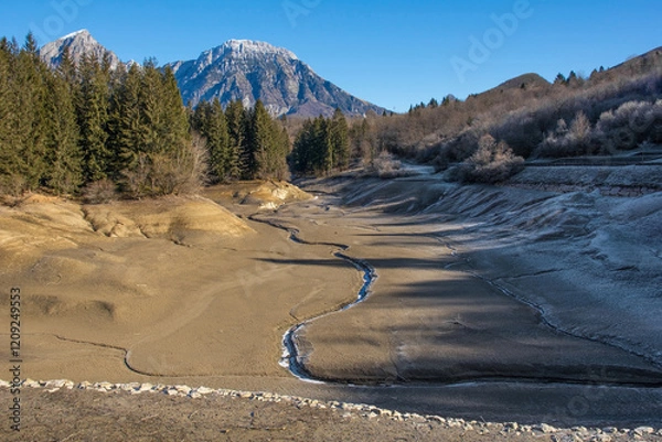 Fototapeta Lago di Barcis - Barcis artificial lake drained of water for routine maintenance, in Friuli-Venezia Giulia, north east Italy. The reservoir was created in 1954 for hydroelectric energy production