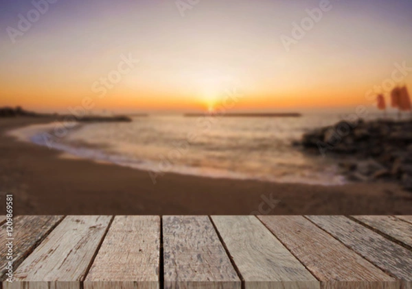Fototapeta Wooden table top on the beach or sea.Party on the beach  sunset time concept.For montage product display or design key visual layout.View of copy space.