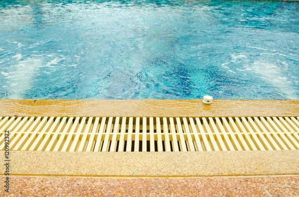 Fototapeta swimming pool and gutter water overflow and sandwash terrace. at the hotel.