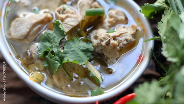 Fototapeta Spicy Chicken Soup,Chicken tom yum in a white bowl with vegetables