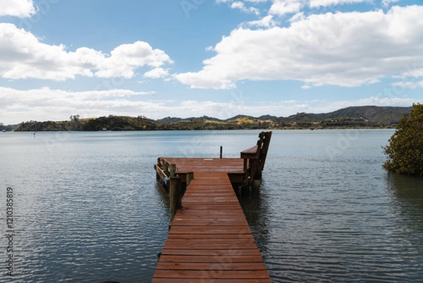 Fototapeta Jetty with view of Pipiroa Bay near Paihia as photographed during a hike in the Bay of Islands (North Island, New Zealand)