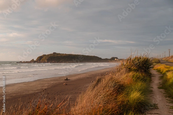 Obraz View of beautiful sunset on the shore of Cape Foulwind with beach views and rolling dark clouds (Cape Foulwind, South Island, New Zealand)