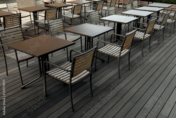 Obraz Cafe tables lined up in the wooden deck courtyard