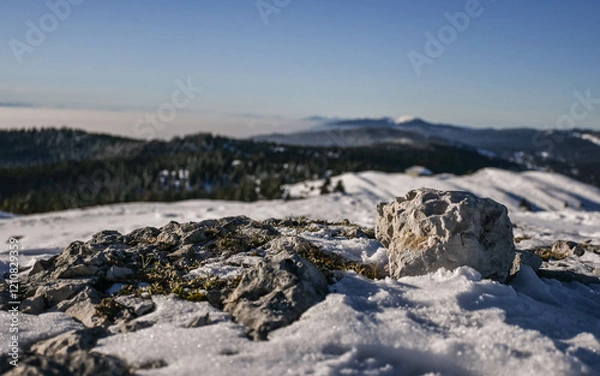 Fototapeta snow covered rocks in the Jura mountains overlooking the forests and a sea of clouds in winter 
