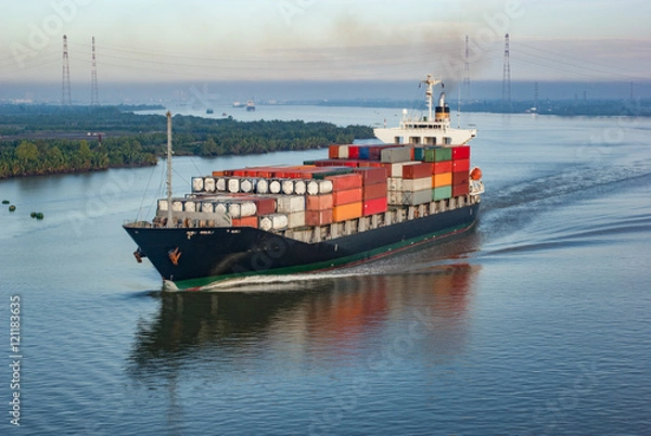 Fototapeta Container ship with many colourful containers in harbour