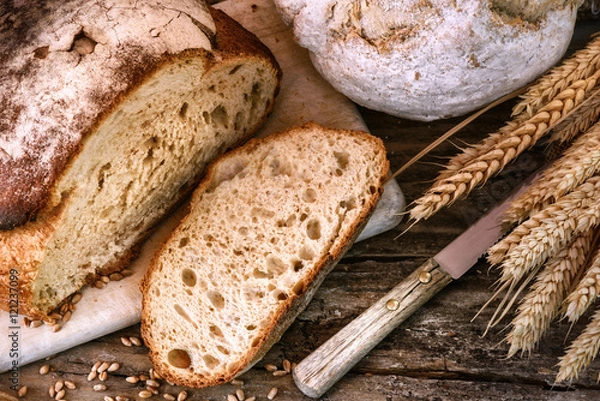 Fototapeta Freshly baked bread in rustic setting