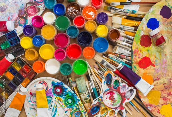 Obraz Colorful paints, brushes, palette on the wooden background. The workplace of the artist. Banner for the school.