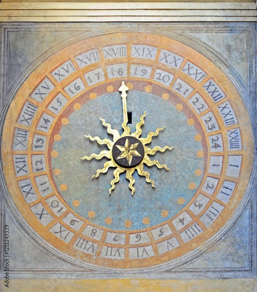 Fototapeta Clock on the backside of the Torre dell'orologio with golden sun in Brescia, Italy