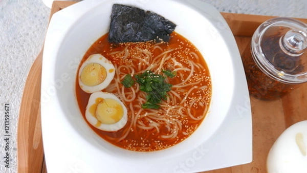 Obraz Ramen noodles with egg and delicious broth with a homemade recipe, and is widely loved in Asia.