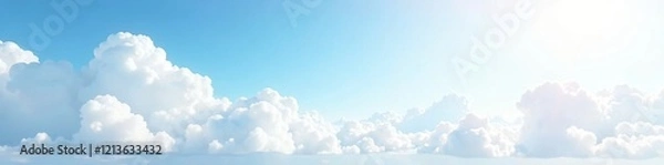 Obraz Bright blue sky with fluffy clouds illuminated by sunlight in a serene landscape.