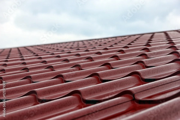 Obraz wet red metal roofing from sheet metal with droplets of rain clo
