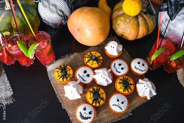 Obraz Group of halloween cupcakes with pumpkin and cocktails background