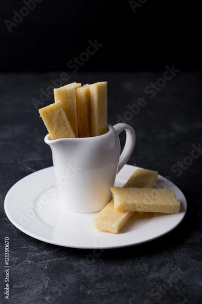 Fototapeta Stack of homemade english shortbread cookies in a milk jug on a plate