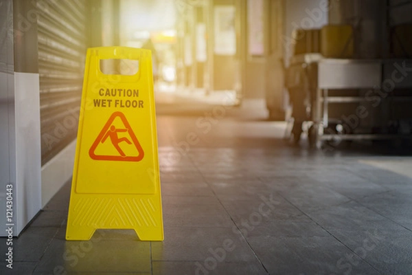Fototapeta Sign showing warning of caution wet floor,selective focus,vintage color.