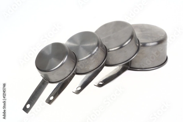 Fototapeta Measuring cups pilled side